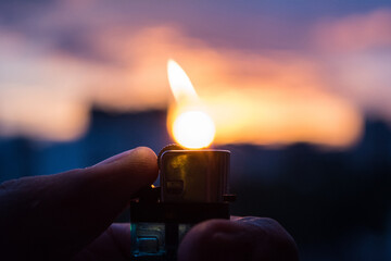 A lighter burning a sun of sunset