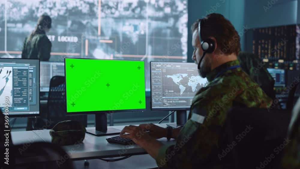 Aufkleber military surveillance officer working on computer with green screen in central office for cyber oper