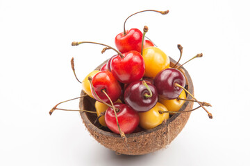 juicy cherry berry in a bowl of coconut on a white background. fruits and vitamins. healthy food for breakfast. fruits of vegetation. fruit dessert
