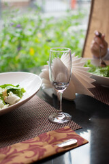 Just a wineglass standing on the table while dinner