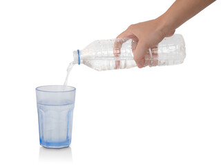 Pouring water from plastic bottle into glass isolated on white. Clipping path