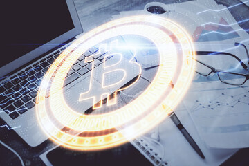 Double exposure of blockchain and crypto economy theme hologram and table with computer background....