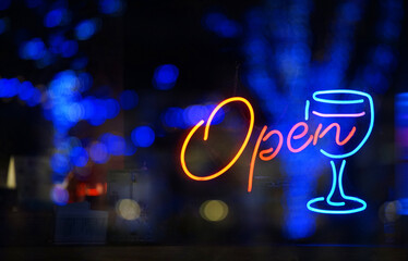 Neon sign to see from the glass of the night window