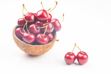 juicy cherry berry in a bowl of coconut on a white background. fruits and vitamins. healthy food for breakfast. fruits of vegetation. fruit dessert