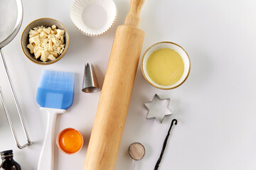 food, culinary and recipe concept - cooking ingredients and kitchen tools for baking on table