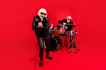 Full length photo of grey white hair two people pensioner wife husband rock band man play drum...