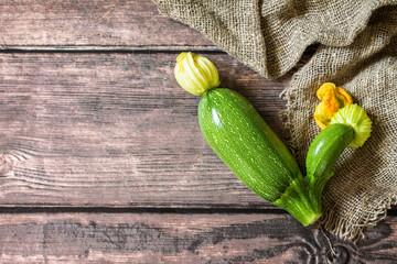 Fresh vegetable. Ugly organic twisted zucchini on wooden table. Copy space. Top view flat lay background. Copy space.