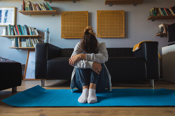 Frustrated and tired spoprty woman crying alone at home. Workout fail and lack of motivation...