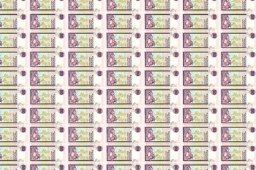20 Sri Lankan rupees bills printed in money production conveyor. Collage of many bills. Concept of...
