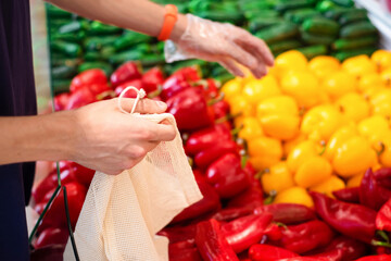 Man in supermarket with eco bag taking products