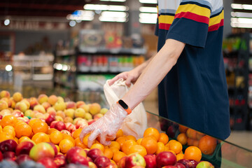 Man in supermarket with eco bag taking products