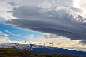 Beautiful clouds over the hilly landscapes of Iceland. Nature and places for wonderful travels