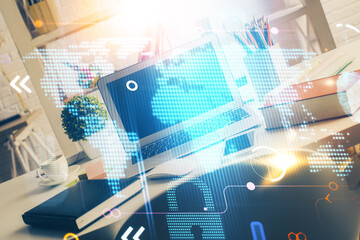 Double exposure of desktop with computer and world map hologram. International data network concept.