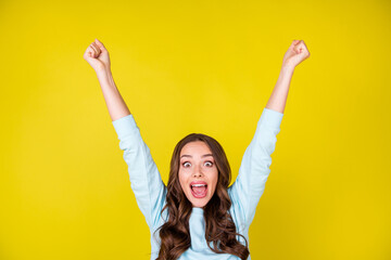 Photo of cute lovely insane young girl raise hands fists euphoric look open mouth first place...