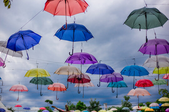 Blurred abstract background of colorful umbrellas used to decorate the interior of parks or restaurants, cafes, to grab the attention of customers and take pictures while visiting.