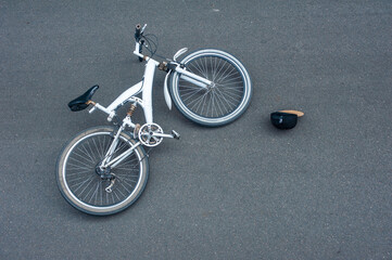 An accident on the road. The bike lies on the asphalt.