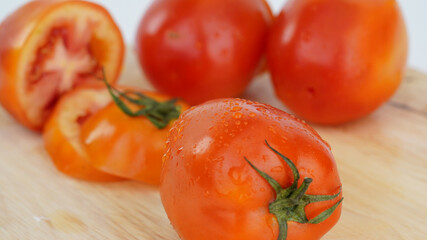 Fresh vegetables, Red, bright, juicy, fresh tomatoes isolated on cutting board.