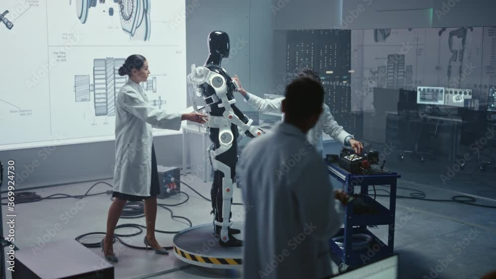 Poster In Robotics Technology Development Laboratory Diverse Team of Engineers Work on a Bionics Exoskeleton Prototype. Scientists Design Powered Armor Suit to Help Disabled People and Hard Labor Workers