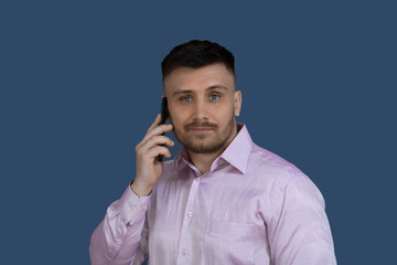 Smiling man calling on the phone.Man on a gray background.