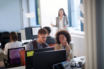 Young man and woman working together in the office