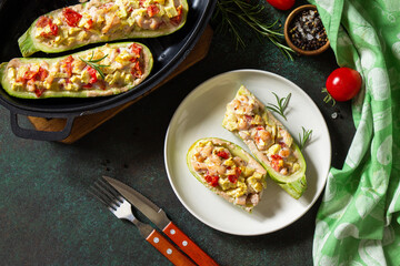 Healthy food concept. Baked zucchini with meat and tomatoes  on a stone table. Top view flat lay background.
