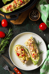 Healthy food concept. Baked zucchini with meat and tomatoes  on a stone table. Top view flat lay background.