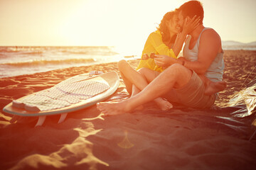 Young attractive surfing couple kissing