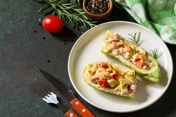 Healthy food concept. Baked zucchini with meat and tomatoes  on a stone table. Copy space.