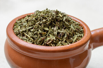 Dried thyme (Thymus) in a earthenware bowl.