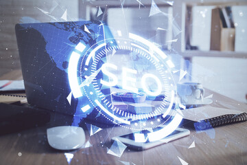 Multi exposure of table with computer and seo drawing hologram. Search optimization concept.