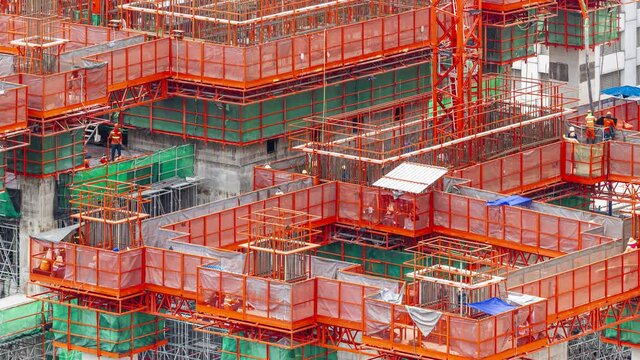 Footage 4k Timelapse, Overhead view of construction workers fabricating steel reinforcement bar on A suspended platform at the skyscraper construction site, The reinforcement bar was tied together.