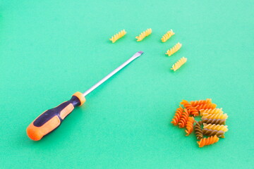 composition of colored spirals and screwdriver on eye-catching background