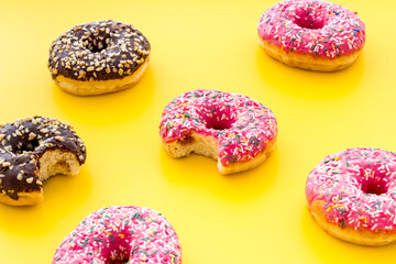 Colorful donuts close up, glazed and sprinkles bakery