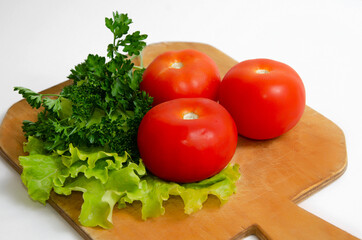 Three Big Tomatoes Greens Wooden Board Healthy Food Concept Vegetarianism, keto diet, paleo diet