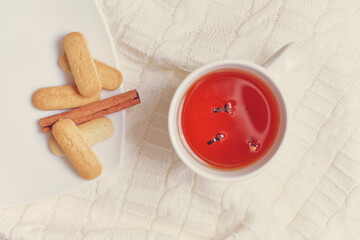 Autumn concept with tea, scarf and cookies with top view