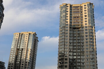 Fototapeta premium Scenic view of contemporary residential houses on a cloudy day. True modern cityscape of the Ukrainian capital. Design of contemporary build in big city. Real urban style of residential building.
