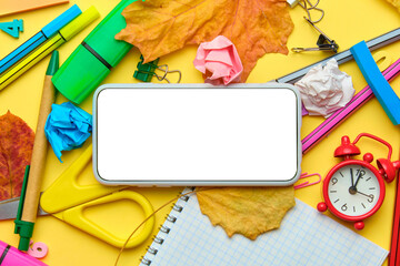 Back to school concept with mobile phone for copy space and office supplies around
