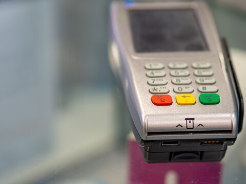Close up of a credit and debit card reader. Payment terminal on a store counter.
