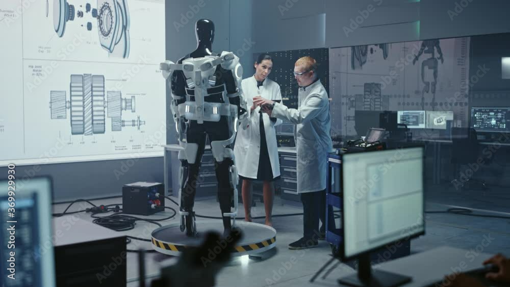 Poster in robotics development laboratory: chief female engineer and top male scientist work on a bionics e