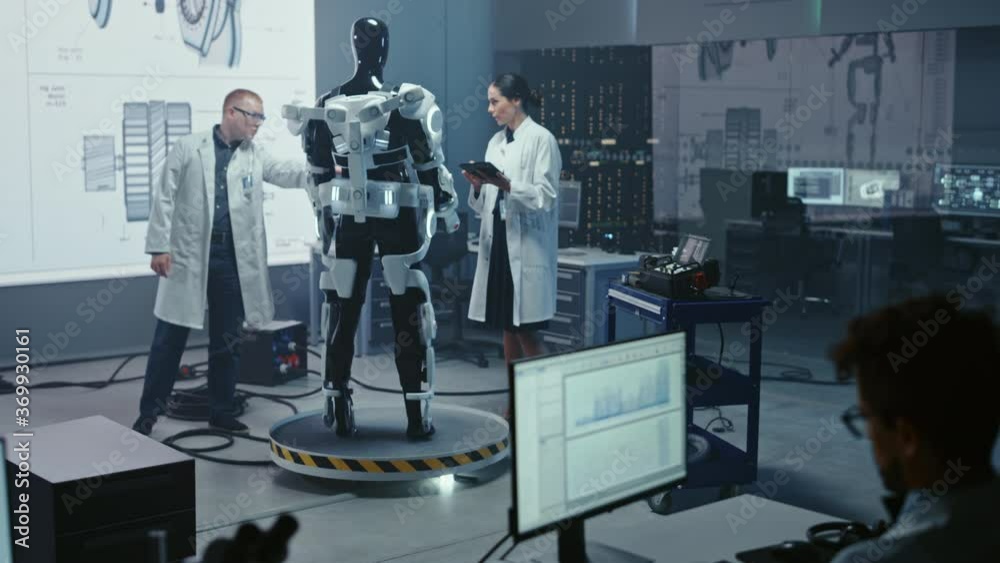 Poster in robotics development laboratory: chief female engineer and top male scientist work on a bionics e