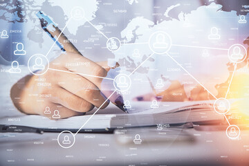 Social network theme hologram over hands taking notes background. Concept of global international people connect. Double exposure