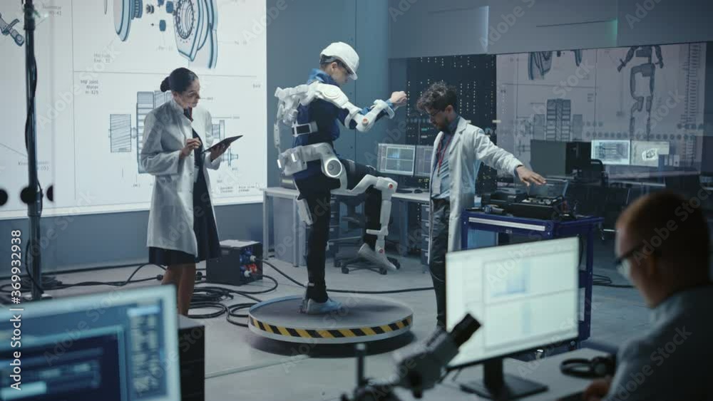 Leinwandbilder In Robotics Development Laboratory: Engineers and Scientists Work on a Bionics Exoskeleton Prototype with Person Testing it. Designing Wearable Exosuit to Help Disabled People, Warehouse Workers
