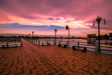 The blurry abstract background of the morning sky by the reservoir and there is a walkway to watch nature for exercise or rest while traveling