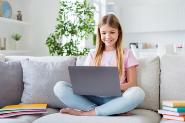 Full length photo of positive smart kid girl study remote house use laptop search project...