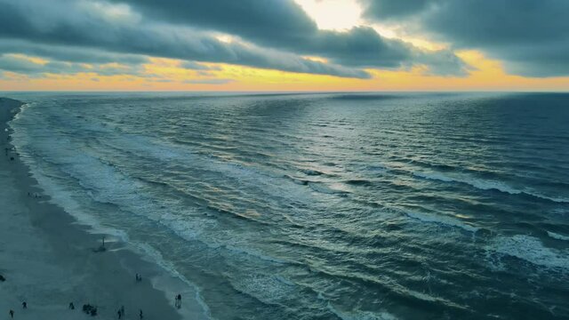 Dramatic sunset over the beach of Karwia on the Polish coastline. Drone elevation shot.