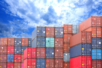 Vertical row of four container containers of different colors in the harbor