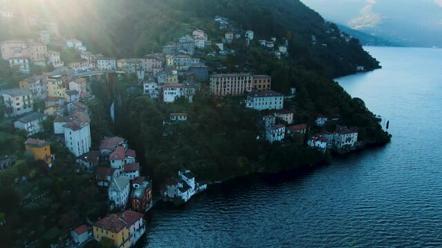 Italy - Lake Como - Flying in fron of Bridge of Nesso with the waterfall in the background, sun flares