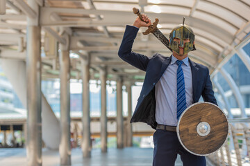 2023, Young businessman holding shield and sword get ready to fight.