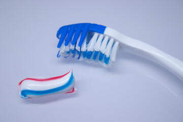 toothbrush on a white background next to the toothpaste. healthy and clean teeth concept, dentistry. High quality photo