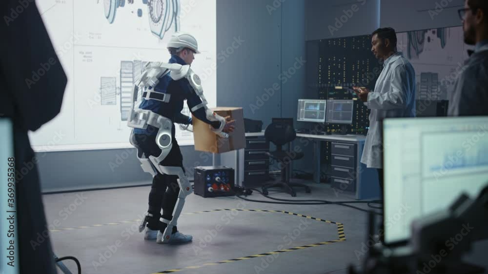 Poster in development laboratory: engineers look at robotics exoskeleton prototype presentation with person